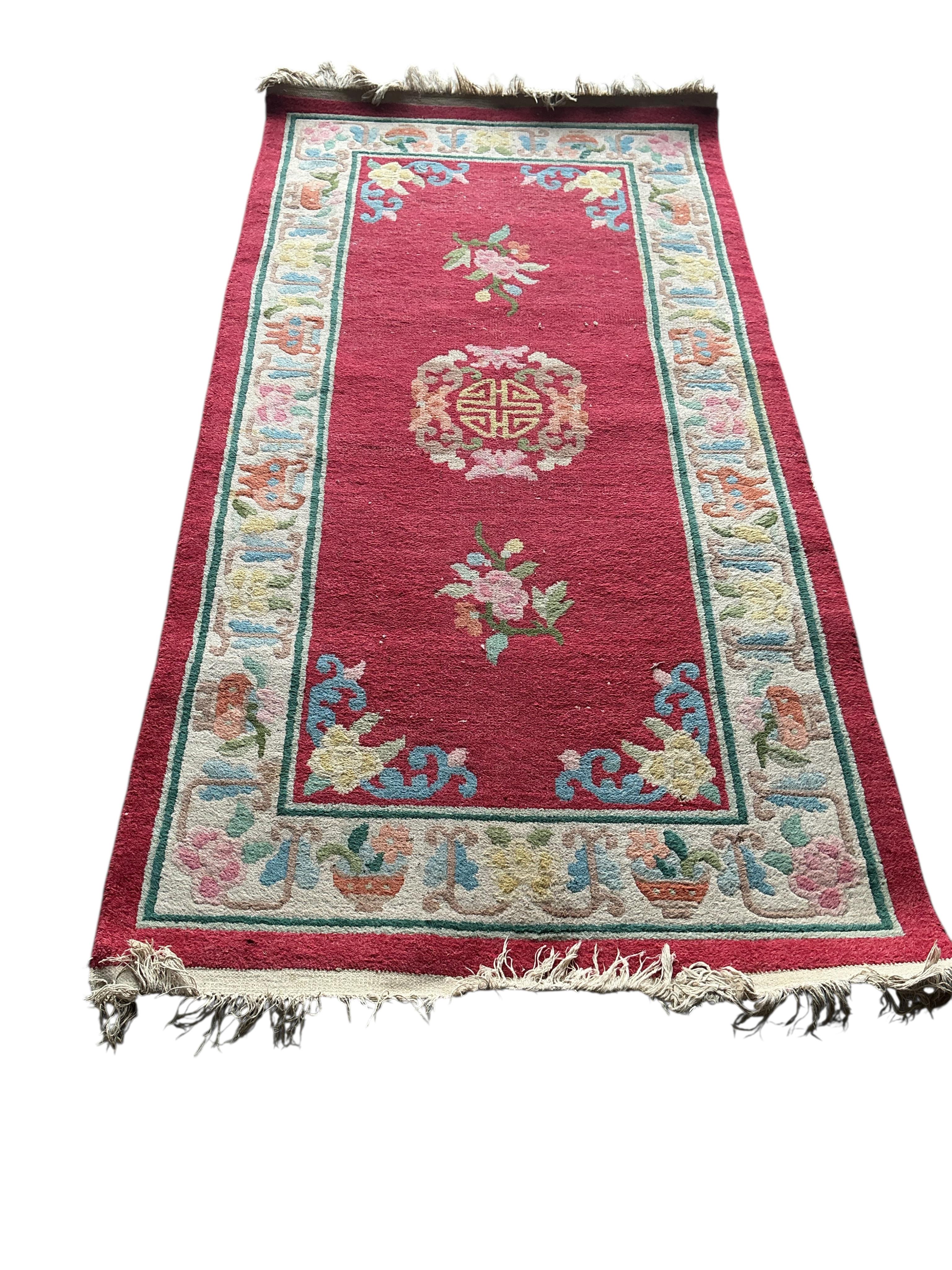 A Chinese red ground rug, 182 x 93cm